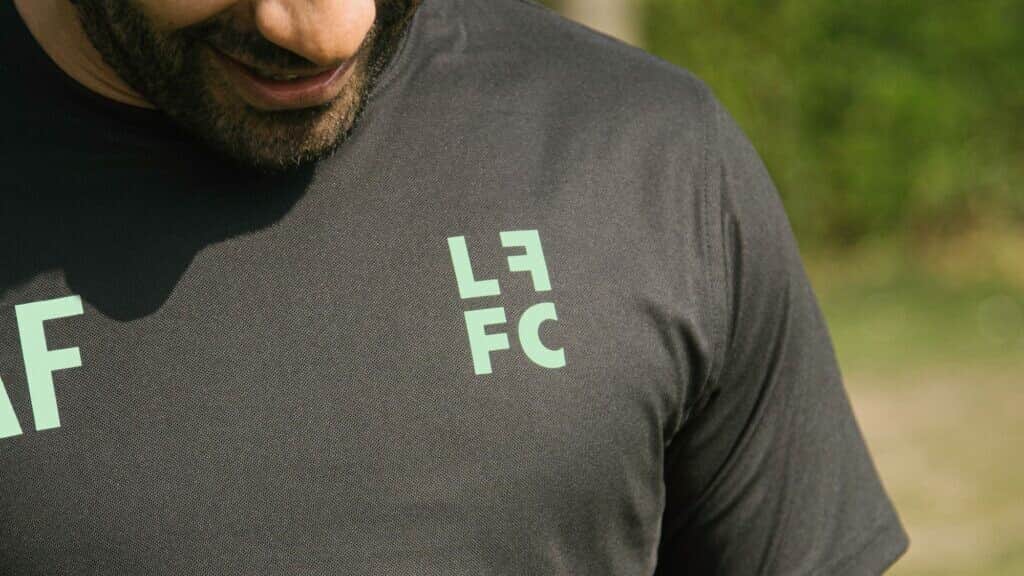 The club crest on the chest of a black training shirt