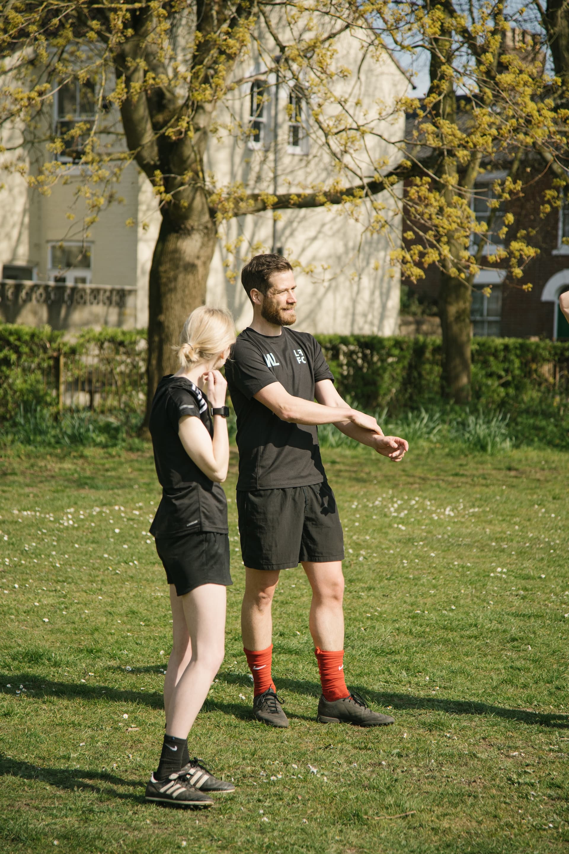Two players talking on the pitch before kick-off